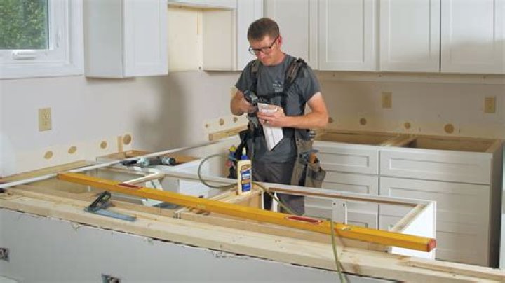Do you install kitchen cabinets before tile flooring?