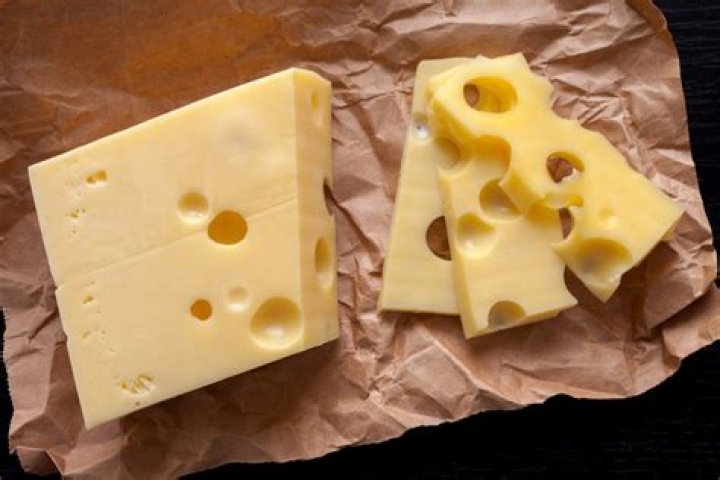 Why does cheddar cheese have holes?